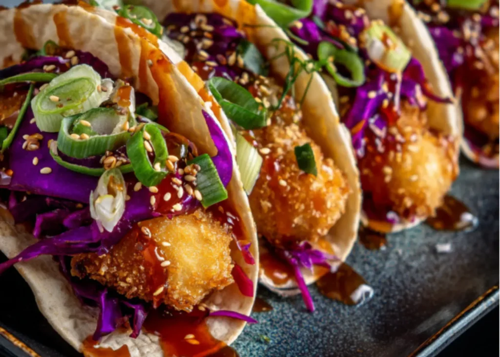 Crunchy Asian-Style Chicken Tacos on a large white platter, crispy baked wonton shells filled with teriyaki chicken,